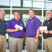 Self Regional Healthcare's Sports Medicine Center staff present Emerald High School and Greenwood High School athletic departments with checks totaling $5,450.