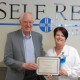 Self Regional's former CEO John Heydel presents Julie Culbertson with the M. John and Drenda Heydel Respiratory Therapy scholarship.