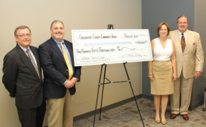 (From left): Mark Kasper from the Greenwood County Community Foundation presents James M. Manley, Treasurer of the Self Regional Healthcare Board of Trustees, with a contribution of $150,000 to benefit women's health initiatives. Kasper was joined by Denise and Jim Medford, owners of the Links at Stoney Point, the site of the charity golf tournament held in May.