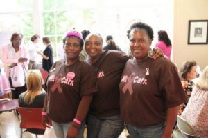 Three women show their tee shirts at the 2012 event.