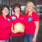 Self Regional Heart and Vascular Team with one of the AED devices to be awarded to a local organization or business.