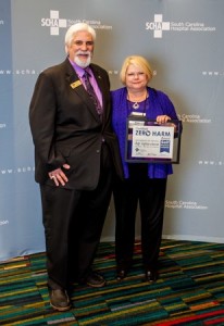 Infection Prevention Coordinator Nancy Lumley from Self Regional Healthcare is presented a Zero Harm Award from the South Carolina Hospital Association's Dr. Rick Foster at a recent meeting in Columbia.