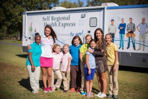 Symetra Tour players Stefanie Kenoyer (left) and JayeMarie Green (right) visit with local students (from left) Shamiya Moraieune, Katie Kellum, Summer Karle, Jennings Brasier, Dru Strickland, Clary Pederson and Collins Strickland featuring the Self Regional Health Express. The Self Regional Healthcare Foundation Women's Health Classic will benefit women's health initiatives in the Lakelands, including support for the Health Express, which offers health outreach, including screenings and education. 