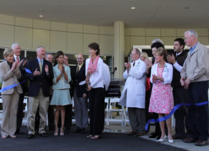 Former patient Lynn Johnson cuts the ribbon for the new consolidated Self Regional Healthcare Cancer Center. 