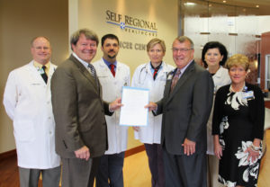 Pictured from left are: Dr. John Funke, radiation oncologist; Rep. Pinson; Dr. Brian Hunis, medical oncologist; Dr. Joanna Sadurski, medical oncologist; Pfeiffer; Dr. Lena Vician, medical oncologist; and Kendra Keeney, Administrative Director of Cardiovascular and Cancer Services at Self Regional.