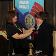 Lorraine Angelino of Greenwood is installed as the new Rotary District Governor during a special event held at Piedmont Technical College in June. Here, she receives a pin from Kim Gramling, the immediate past District Governor, who is from Seneca.
