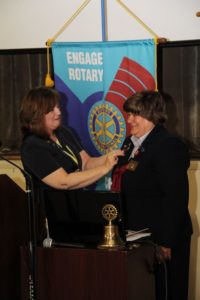 Lorraine Angelino of Greenwood is installed as the new Rotary District Governor during a special event held at Piedmont Technical College in June. Here, she receives a pin from Kim Gramling, the immediate past District Governor, who is from Seneca.