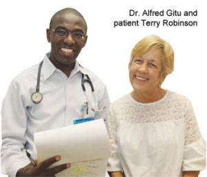 Terry Robinson (right), a patient at the Greater Greenwood United Ministry Free Clinic, said she owes her life to volunteer caregivers Dr. Alfred Gitu (left) and others. She had a tumor removed from her esophagus after a 2006 visit to the clinic. An annual grant from Self Regional Healthcare, along with free office space in the hospital-owned and -maintained building, helps make the ministry possible.