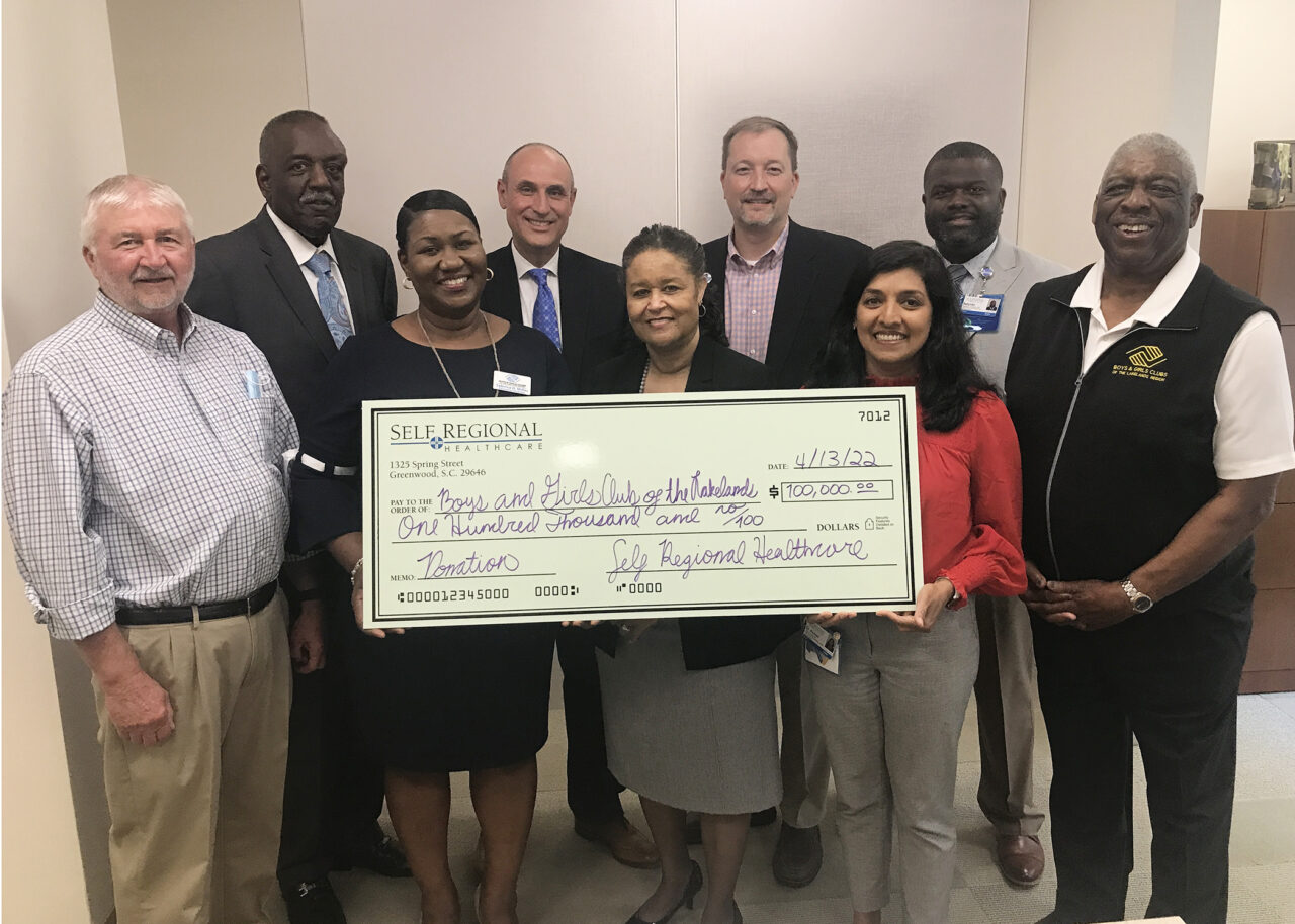 Self Regional Healthcare staff with $100,000 donation check