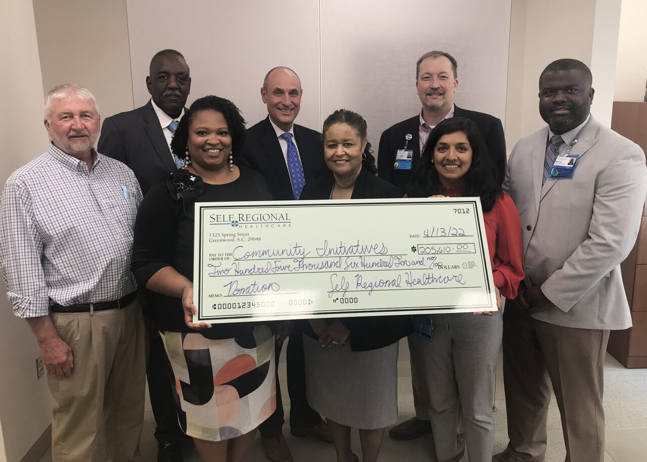 Self Regional Healthcare staff present $255,610 donation check to Community Initiatives