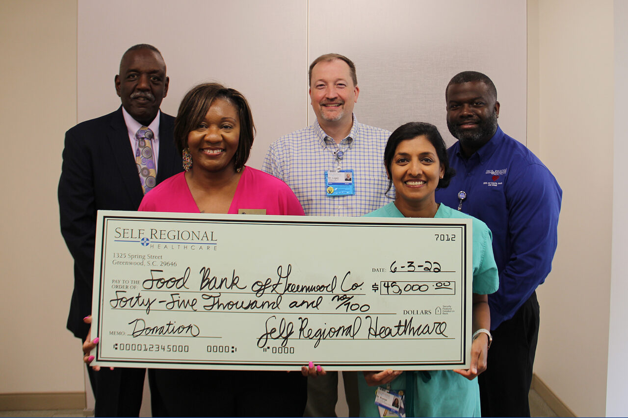 Self Regional Healthcare staff presenting $49,000 donation check to Food Bank of Harwood County.