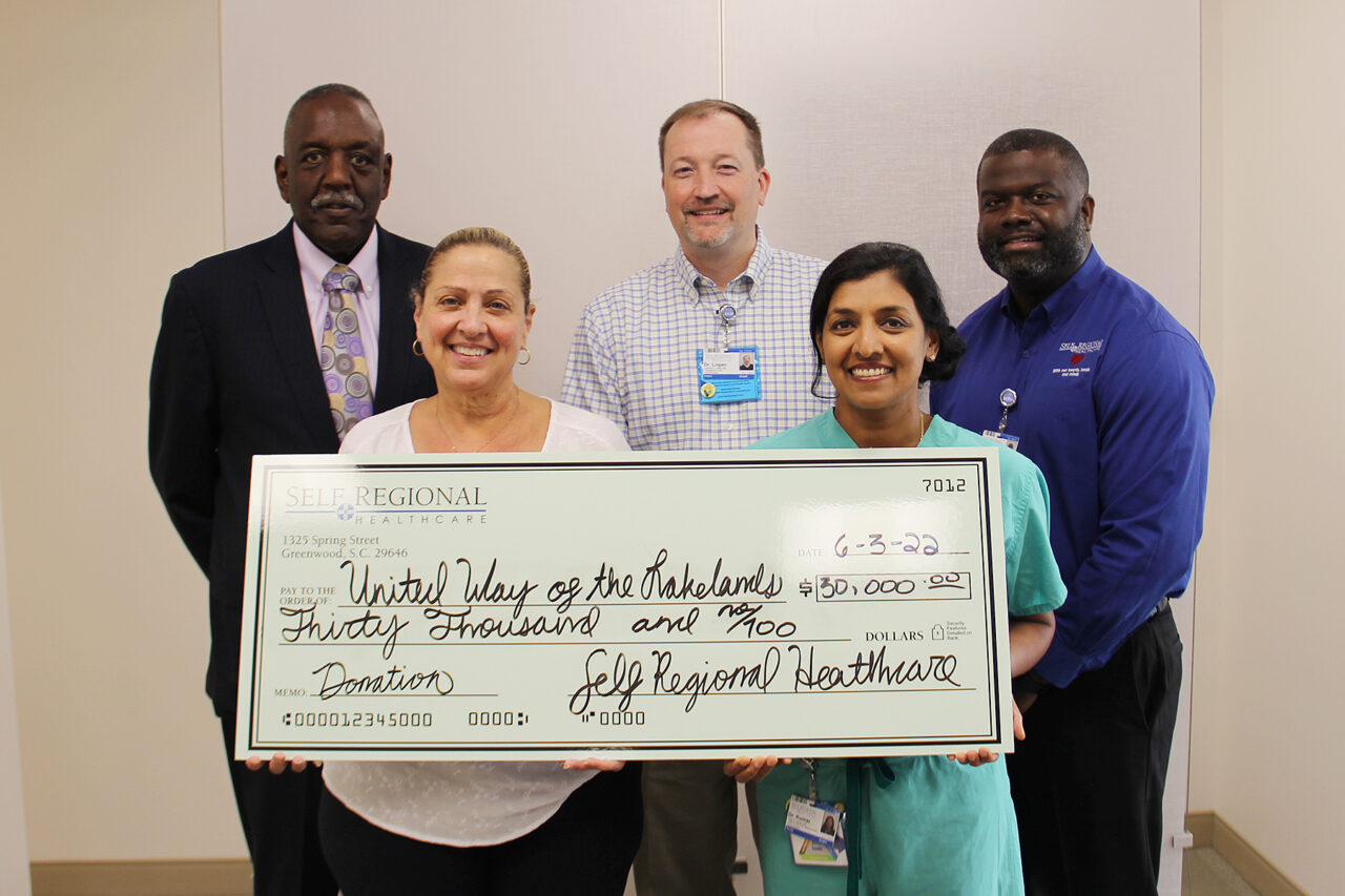 Self Regional Healthcare staff present $30,700 donation check to United Way of the Rakelands.