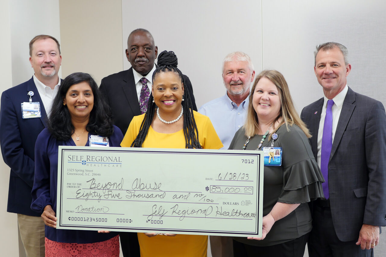 Self Regional Healthcare staff present $85,000 donation check to Beyond Abuse organization
