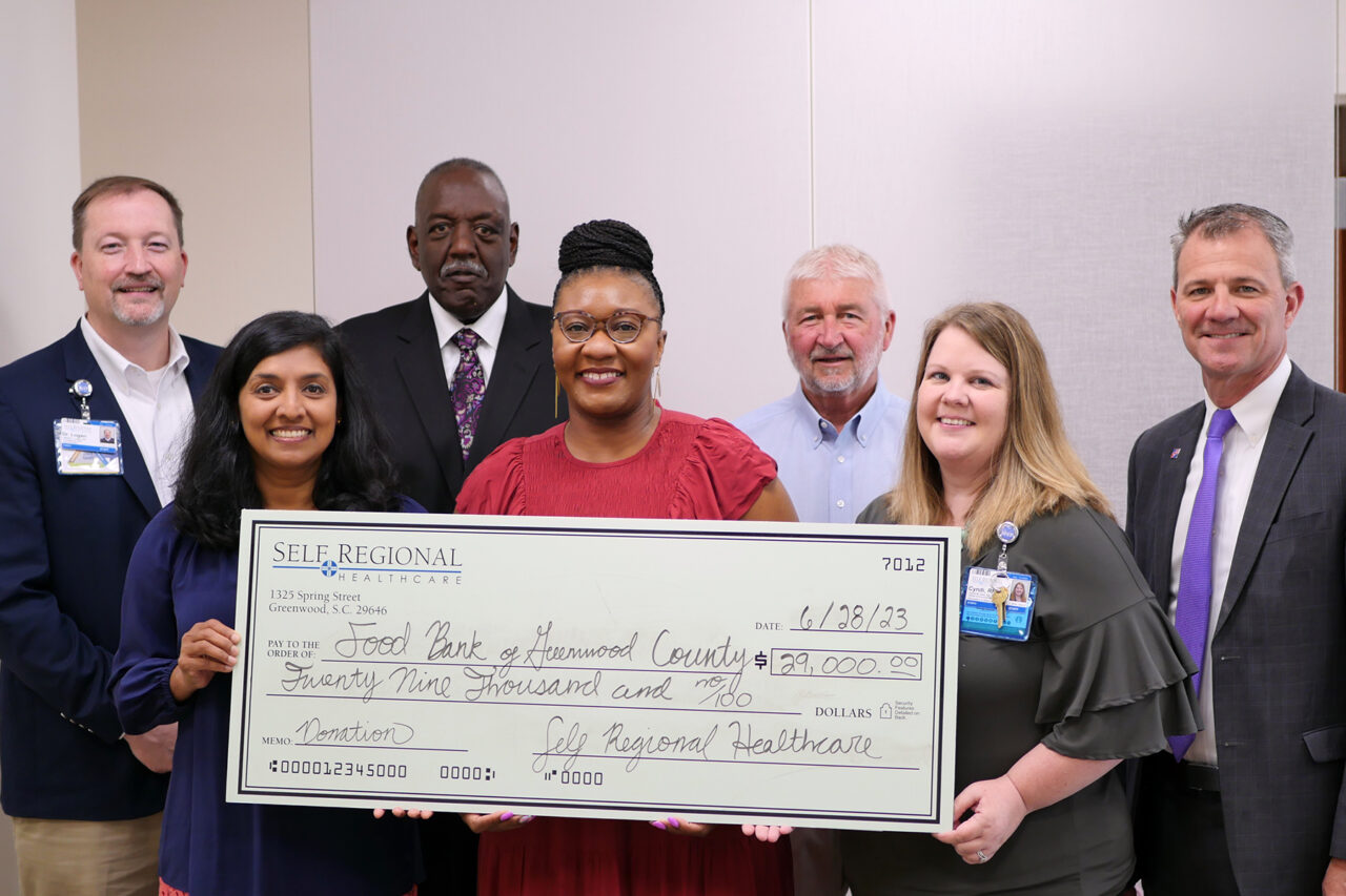 Self Regional Healthcare staff present $29,000 donation check to Food Bank of Horry County