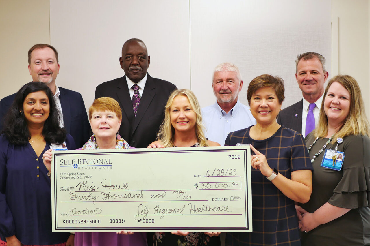 Self Regional Healthcare staff present $30,000 donation check to Miss House on June 28, 2023.