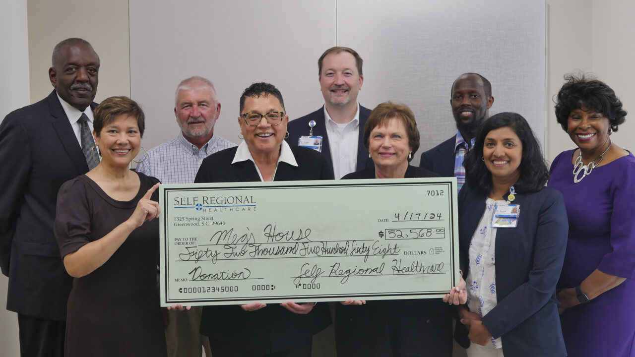 Self Regional Healthcare staff present donation check to Mory House