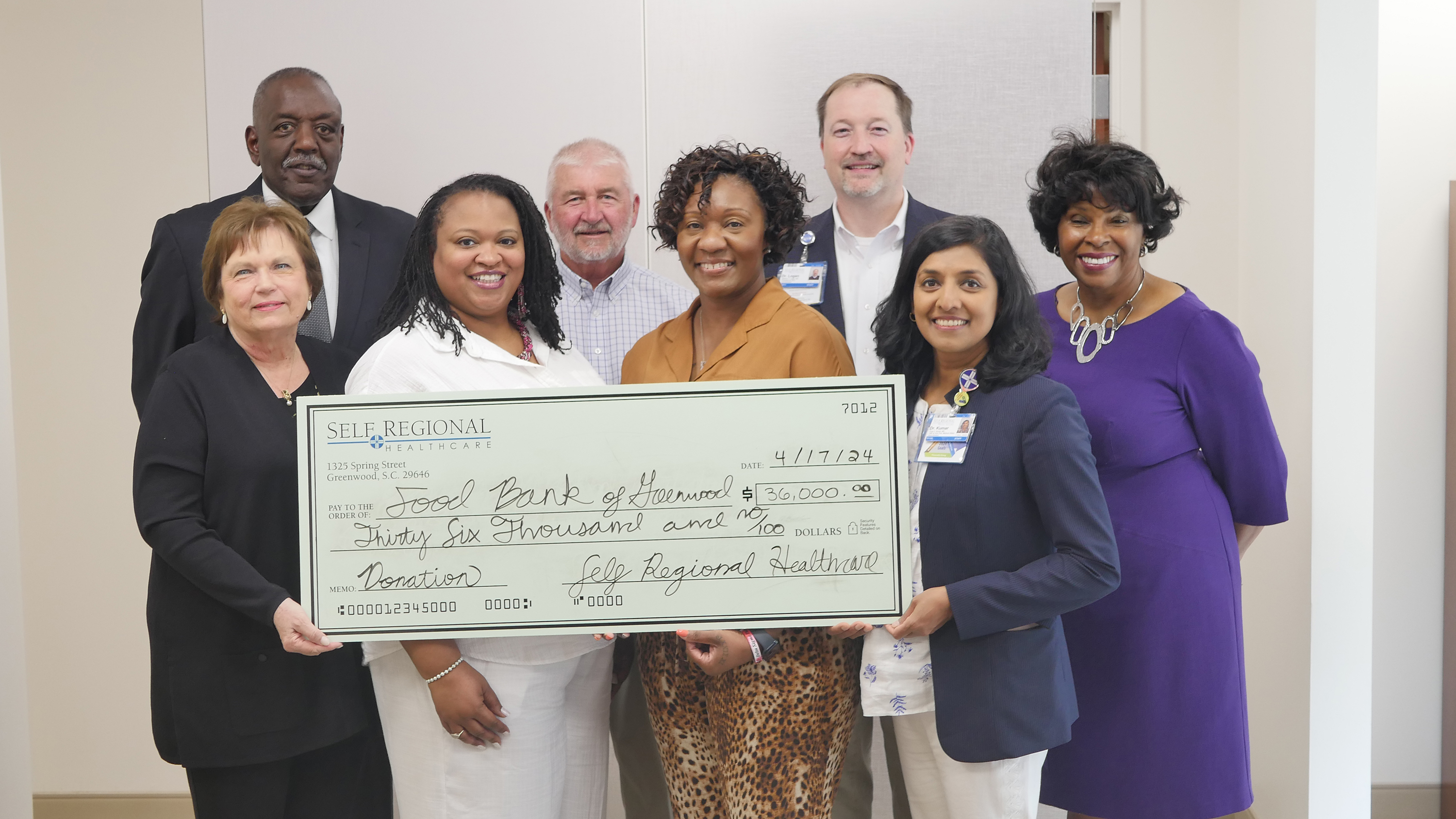 Self Regional Healthcare team members presenting a ,000 donation check to the Food Bank of Harwood.