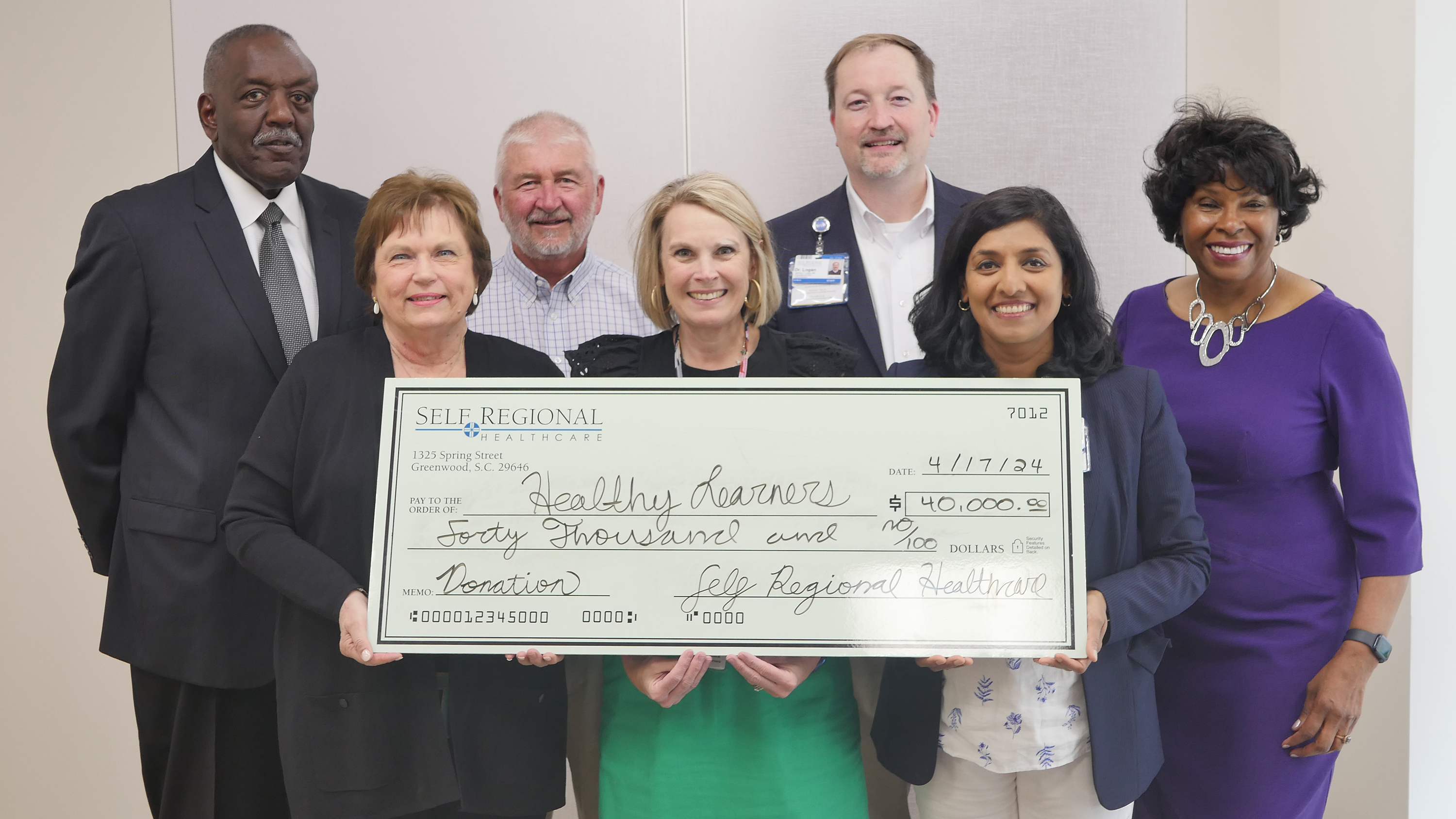 Self Regional Healthcare staff present donation check for Healthy Learners program