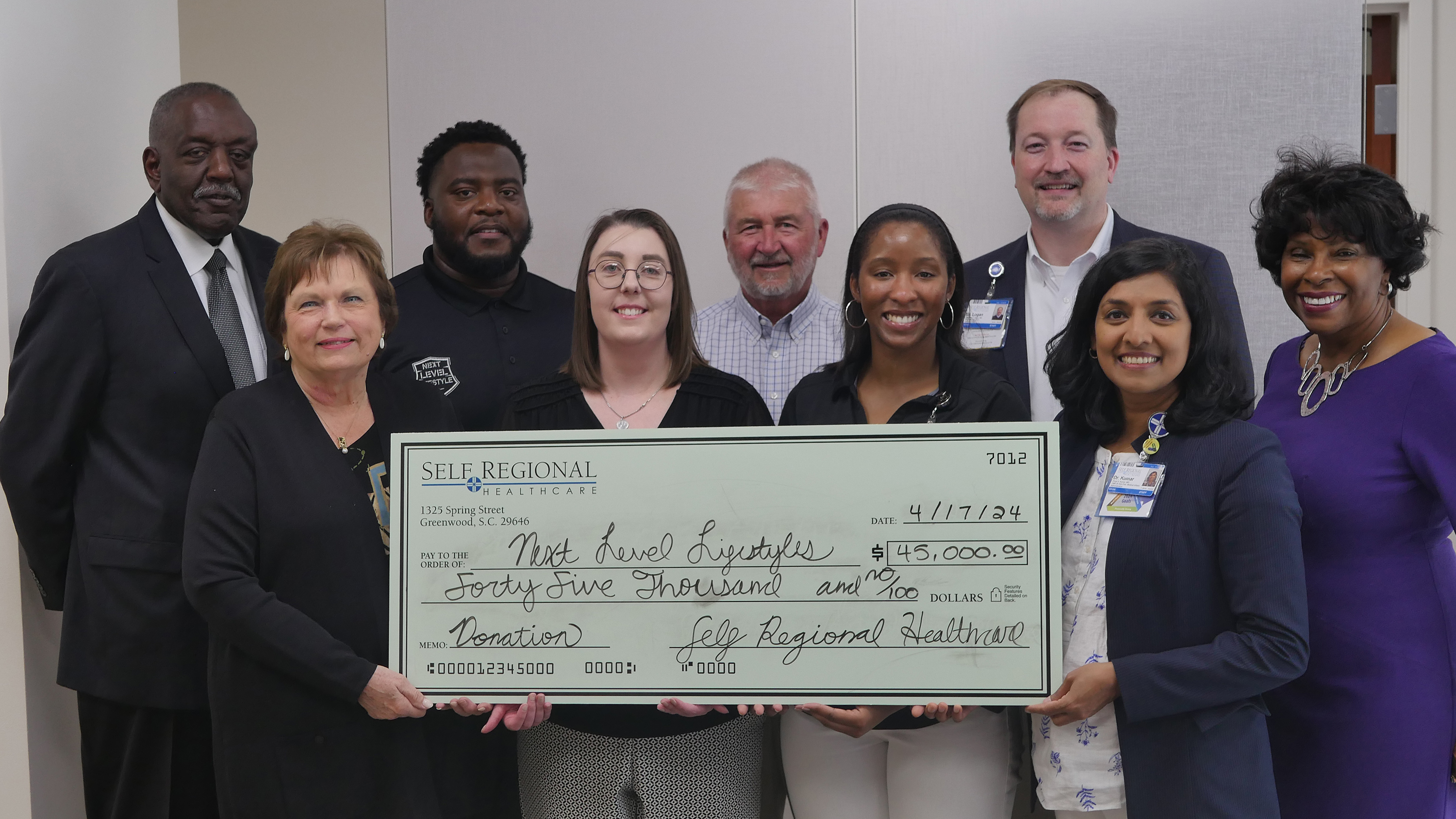 Self Regional Healthcare staff present donation check to Next Level Lifestyles