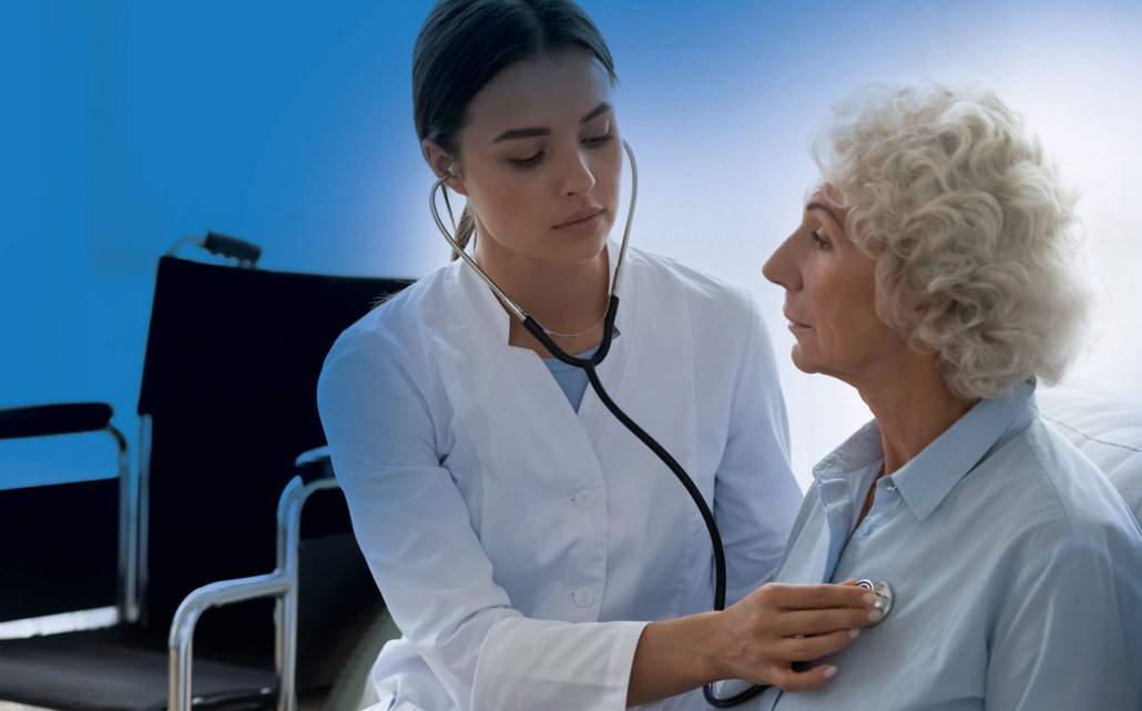 Healthcare provider examining elderly patient with stethoscope