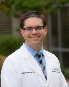 Healthcare provider in white coat and glasses smiling at Self Regional Healthcare