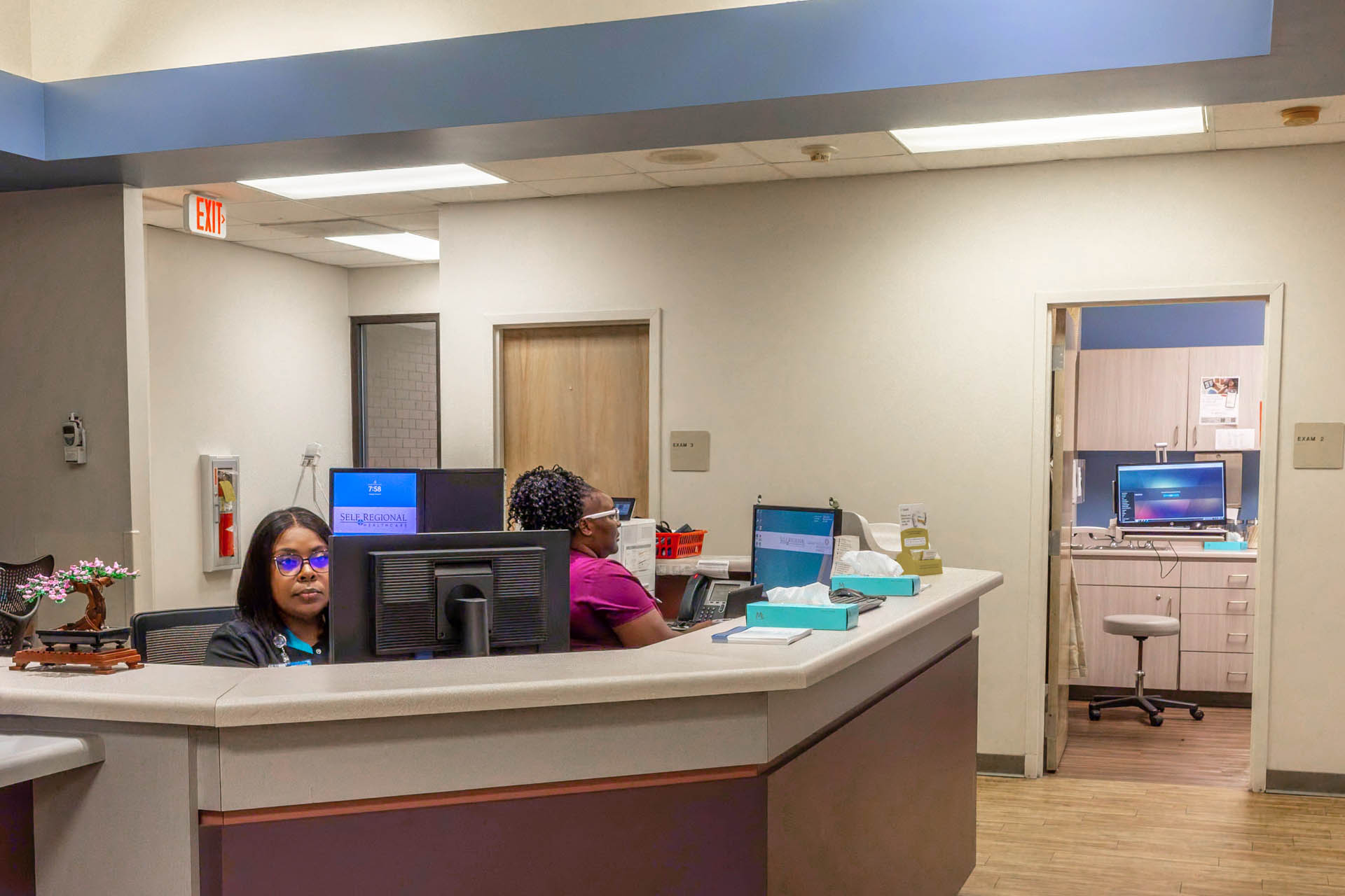 Healthcare reception desk with staff at computers