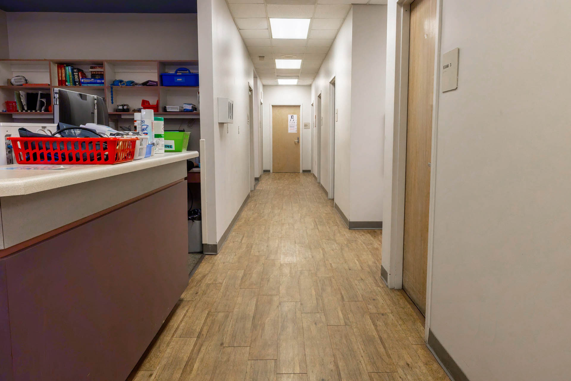 Healthcare facility hallway with reception desk