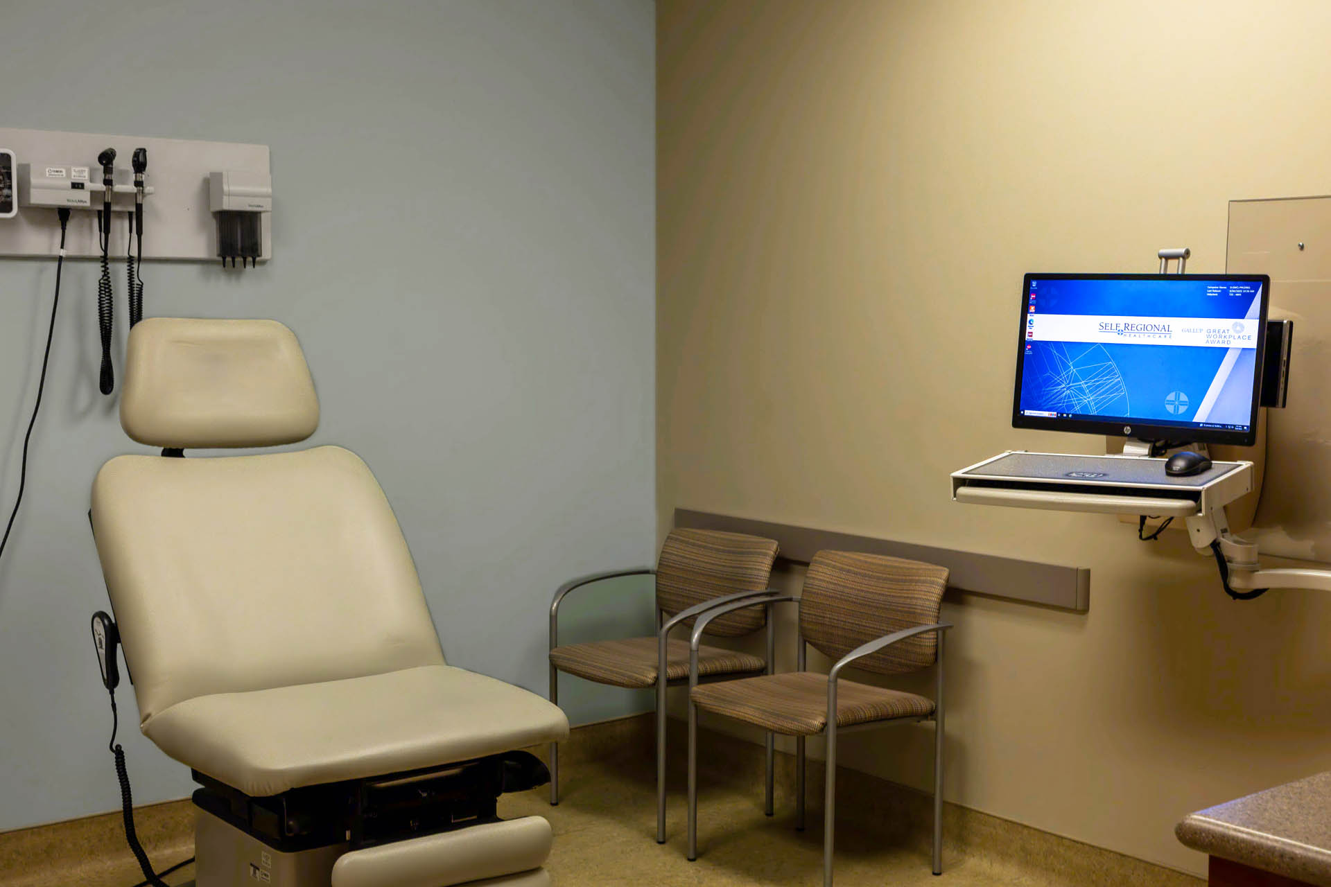 Medical examination room with diagnostic equipment and patient seating