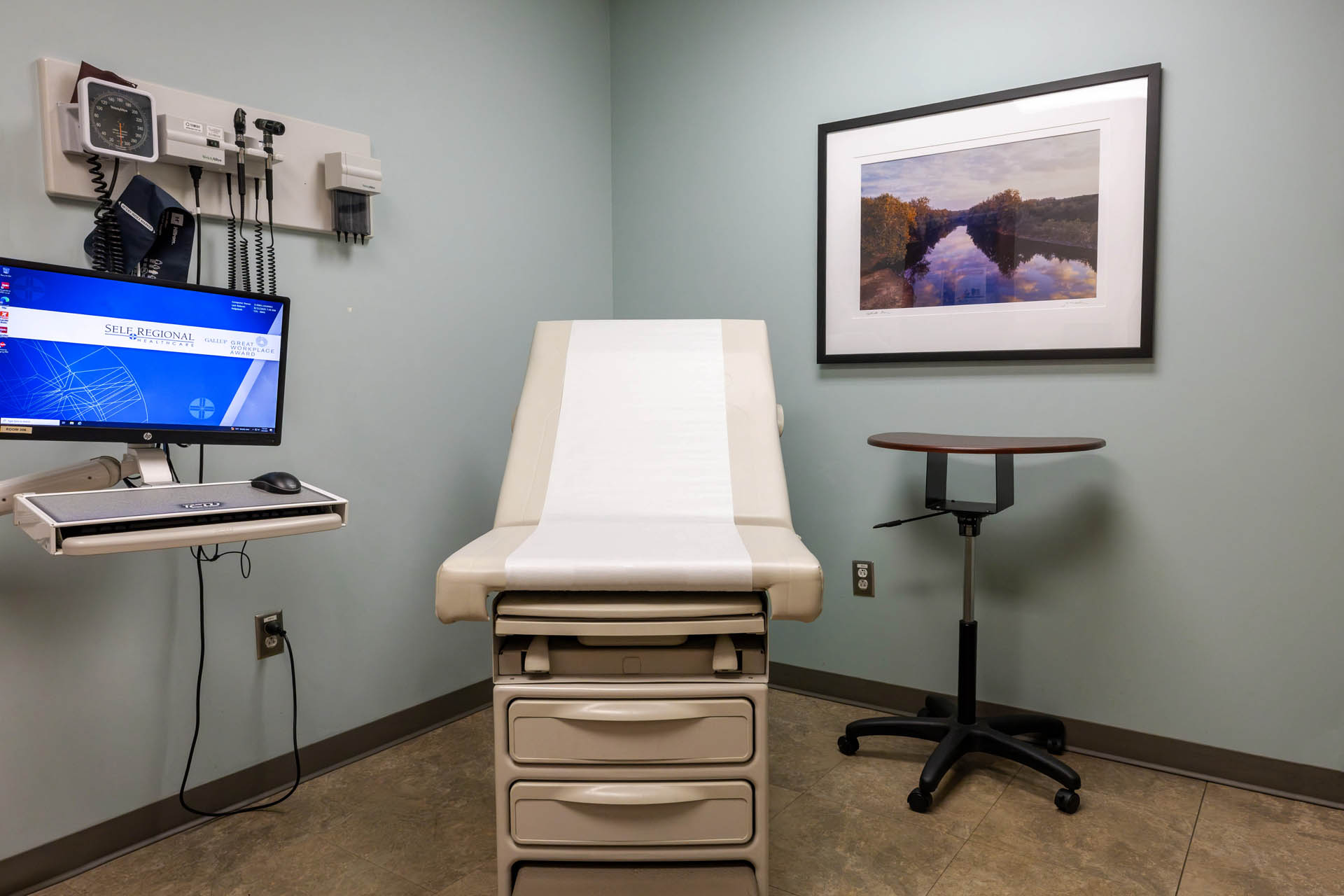 Medical examination room with exam table and diagnostic equipment