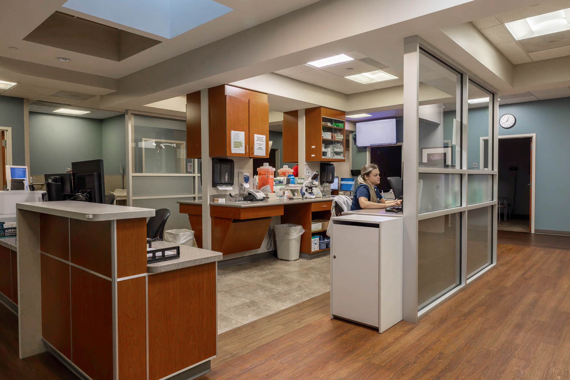 Healthcare clinic reception area with staff at desks