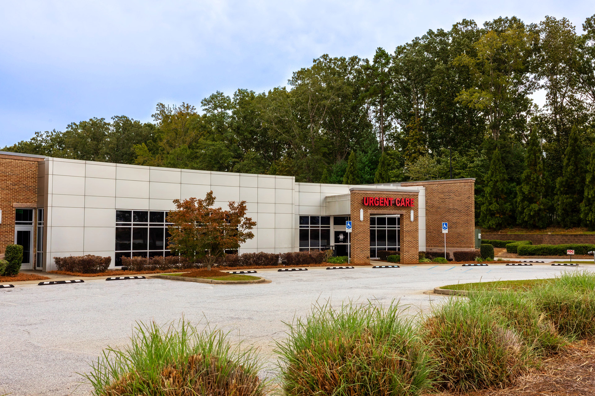 Exterior view of Self Regional Healthcare urgent care facility with brick and metal siding.