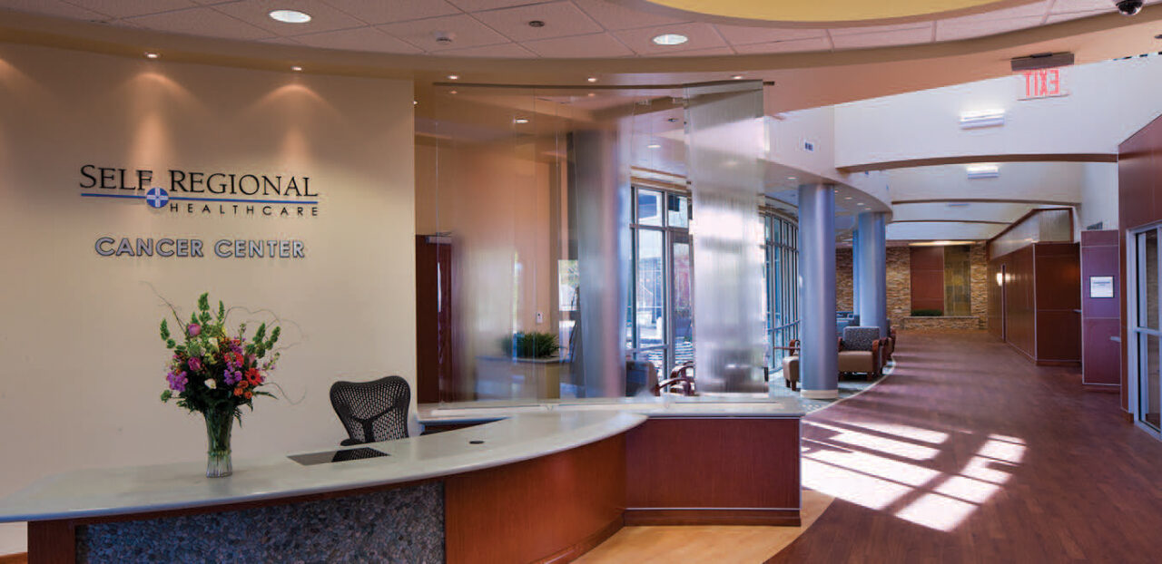 Self Regional Healthcare Cancer Center reception desk with flowers and welcoming waiting area