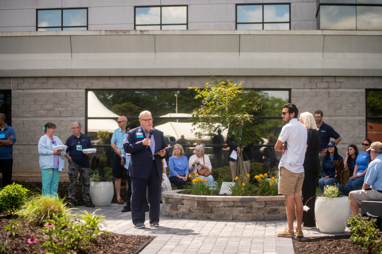 Healthcare staff and visitors outside medical building