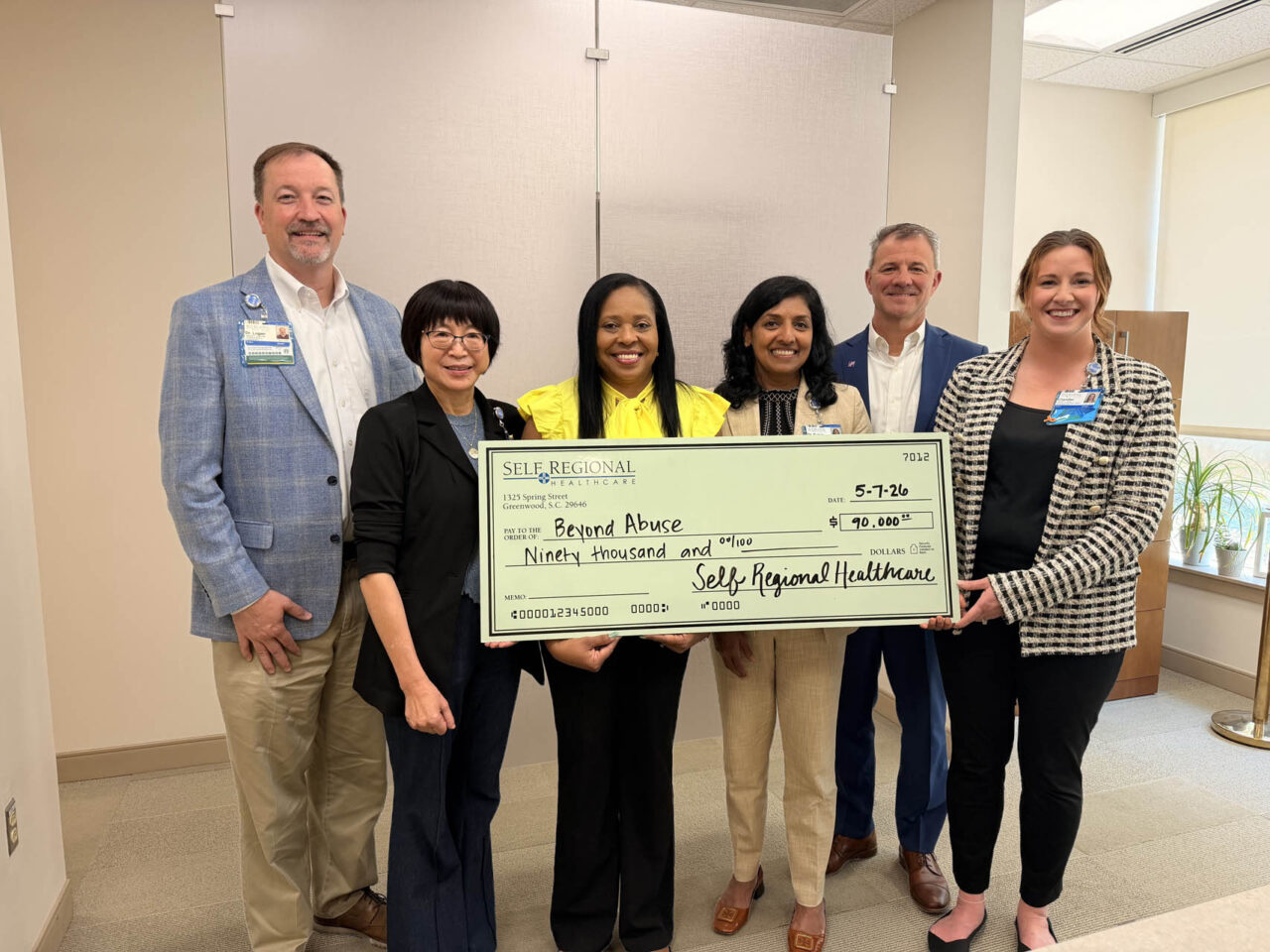 Self Regional Healthcare leaders present a check for 90,000 dollars to Beyond Abuse
