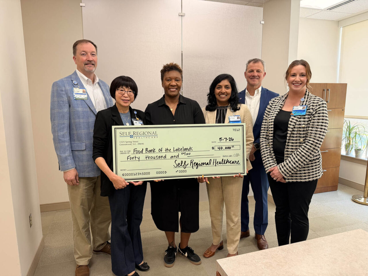 Self Regional Healthcare leaders present a check for 40,000 dollars to Food Bank of the Lakelands