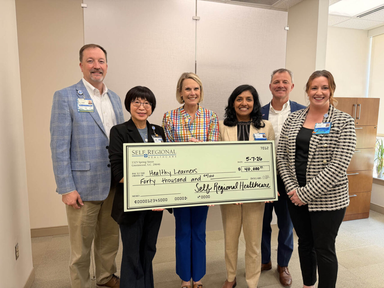 Self Regional Healthcare leaders present a check for 40,000 dollars to Healthy Learners